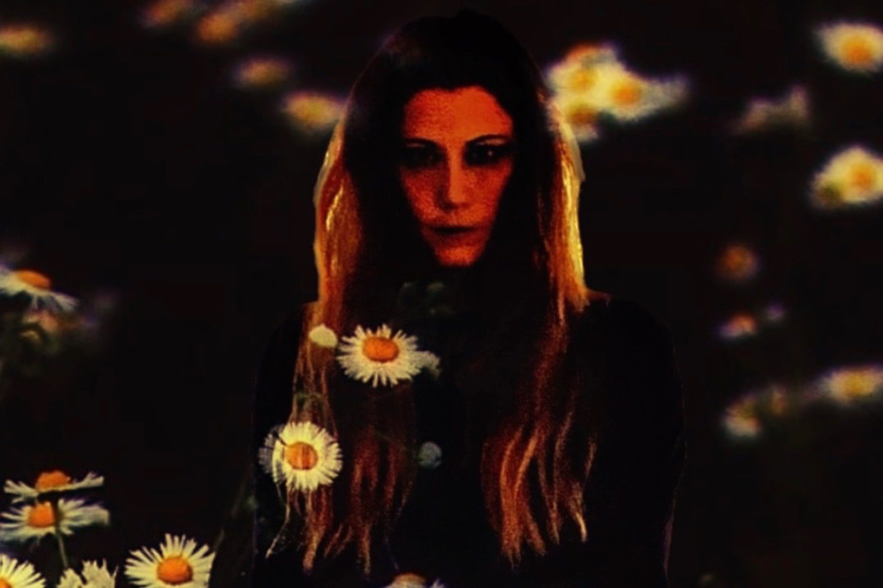 Long-haired woman with daisies projection